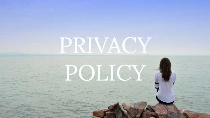 Privacy policy written on image with woman looking out to the sea